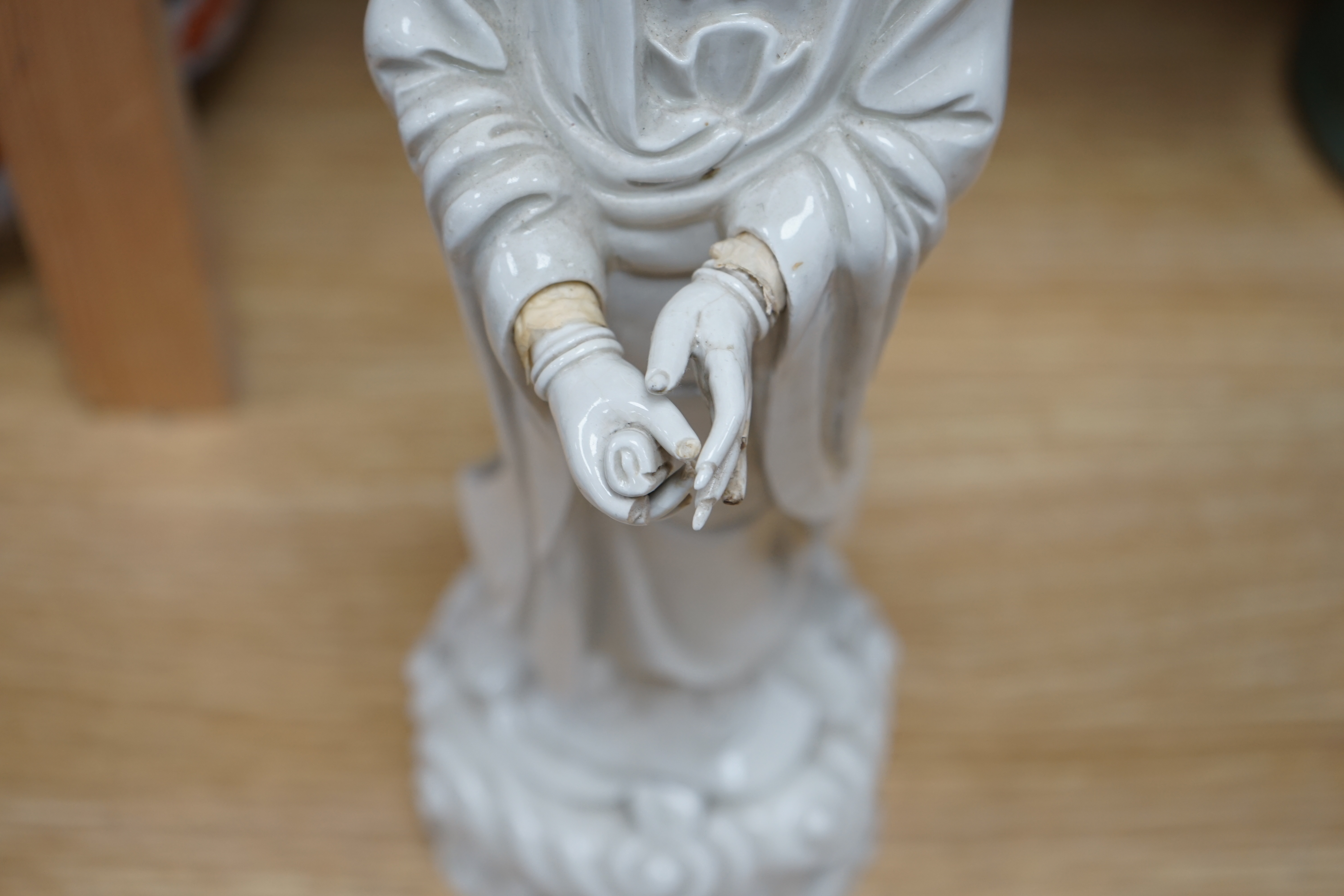 A Chinese blanc de chine figure of Guanyin, early 20th century, 45cm high. Condition - poor to fair, a number of fingers broken and missing